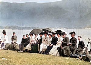 An old photo that had been fully restored, coloured and HD enhanced of people relaxing at the sea wall at Warrenpoint sea front on a sunny day.