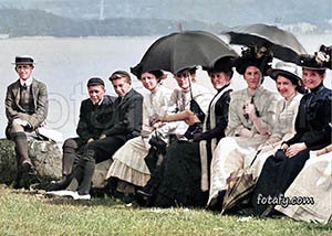 An old image that has been fully restored colourised and HD enhanced of people enjoying the sea air on the promenade in Warrenpoint