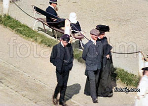 A Victorian photo that has been fullyu restored, colourised and HD enhanced of a couple and a young man enjoying a stroll along the sea front in Warrenpoint