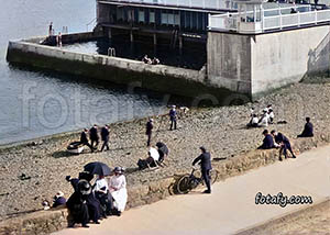 An old image of Warrenpoint swimming baths and people enjoying the sunshine at the sea front. This image has been colourised, HD enhanced and restored