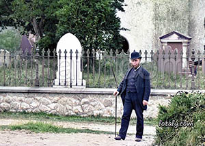 Old image that has been restored, HD enhanced and colourised of a man at the graveyard in the grounds of Clonallen Church Warrenpoint.