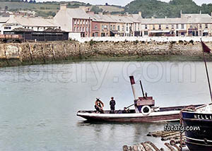 An old image of boatmen in Warrenpoint harbour. The image has been restored and colourised