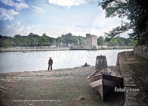 An old image that has been fully restored, HD enhanced and colourised of a docked boat, Newry river and Narrow Water Castle.