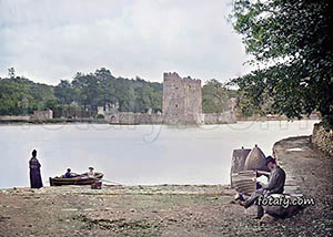 A Victorian image of boys rowing a boat towards Narrow Water Castle, Warrenpoint. The image has been fully restored and colourised