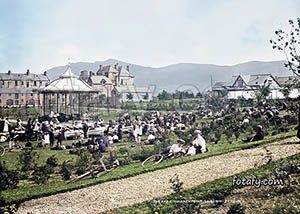 An old image of a large crowd attending a concert at Warrenpoint public park. The image has been fully restored, HD enhanced and colourised.