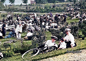 An old image of two ladies and an enfant anong a large crowd attending a concert in Warrenpoint public park. The image had been fully restored, colourised and HD enhanced.