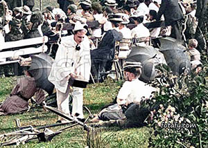 An old image of a jester and beautiful woman at a concert in Warrenpoint public park. The image has been colourised, fully restored and HD enhanced.