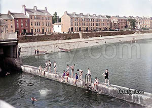 An old image of boys swimming in Warrenpint public baths. The image has been colourised, fully restored and HD enhanced