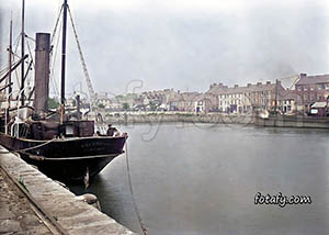 A victorian era image of a docked ship on the quays at Warrenpoint harbour. The image has been fully restored, colourised and HD enhanced